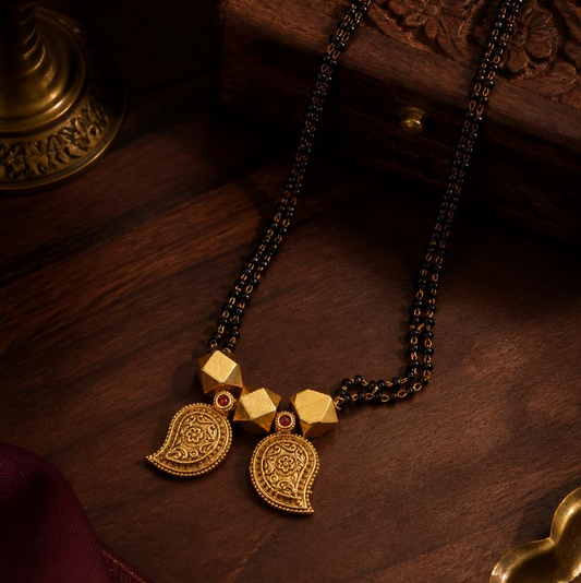 Paisley mango gold mangalsutra double strand black chain with dual engraved mango drop pendants and ruby accent in antique gold finish