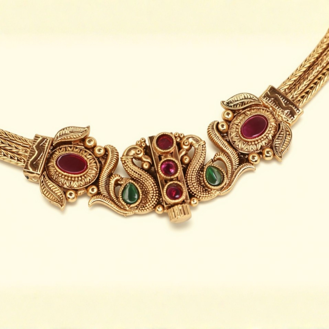 Close-up of South Indian Peacock Chitaag necklace clasp detail with ruby and emerald stone settings