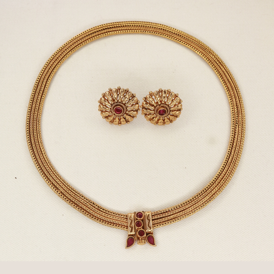 Close-up of Chitaag necklace front clasp with ruby red stones in round and teardrop settings