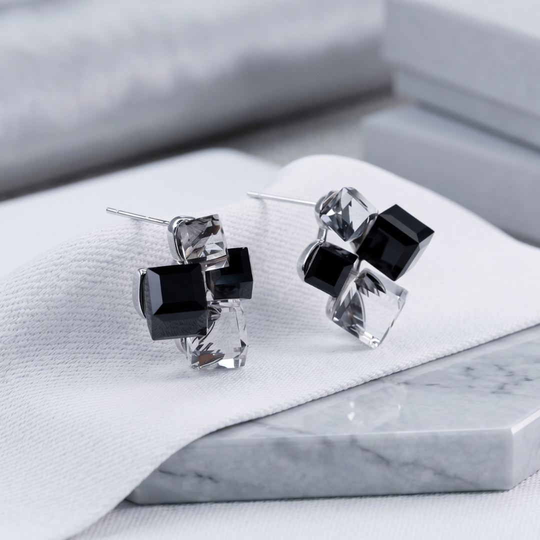 Geometric crystal cube silver-tone push-back stud earrings, close-up detail