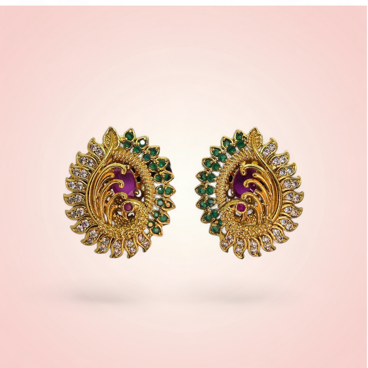 Pair of traditional peacock earrings with CZ border on pink background