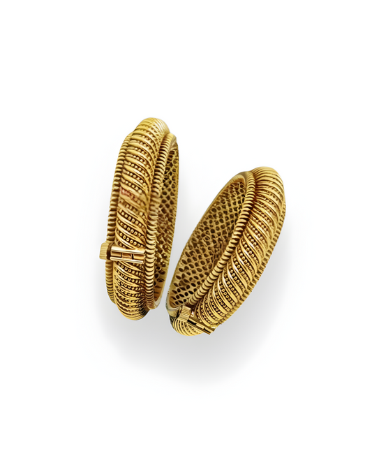 Pair of Shindeshahi Suvarna tode bangles with ribbed gold finish on white background