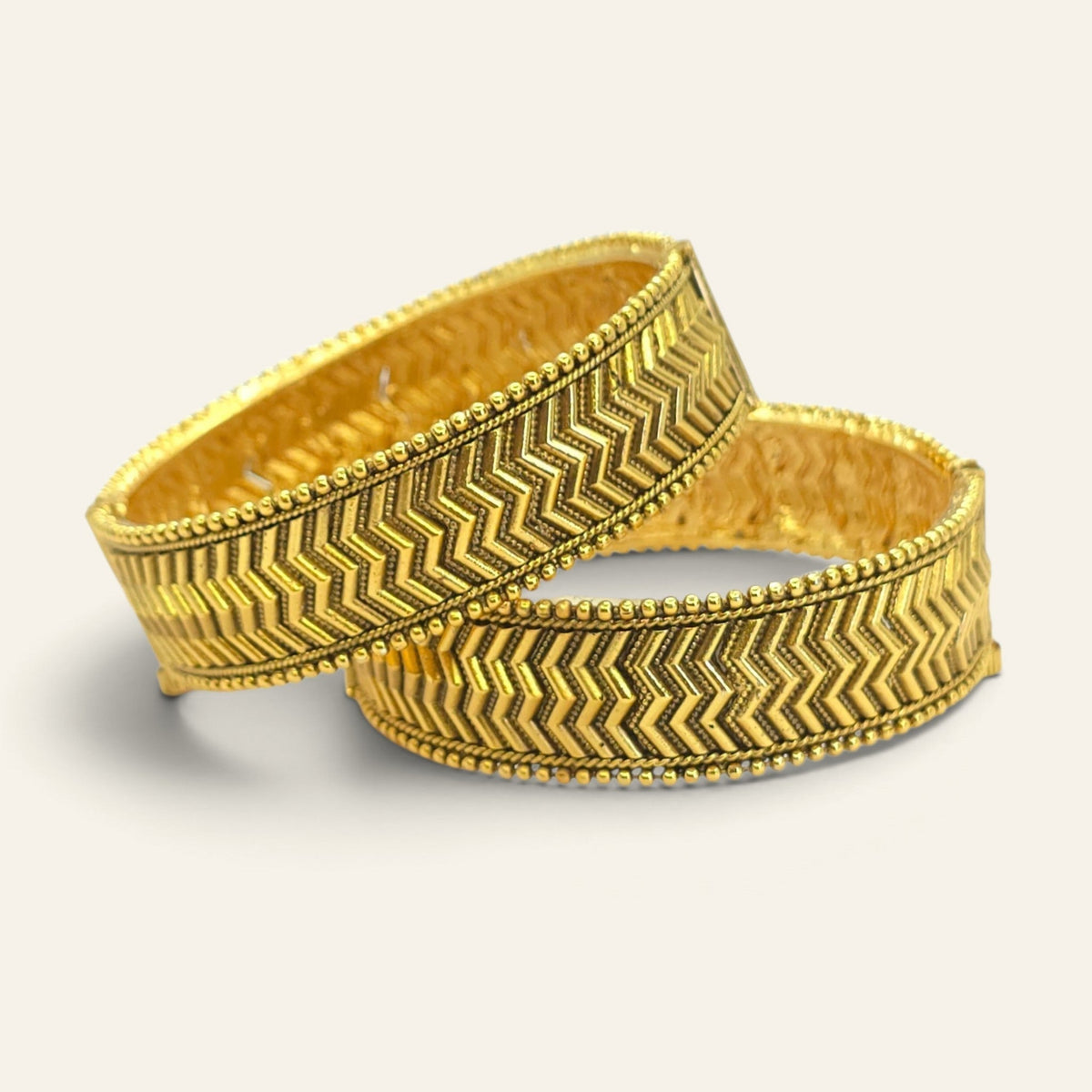 Pair of wide kada-style antique gold chevron bangles