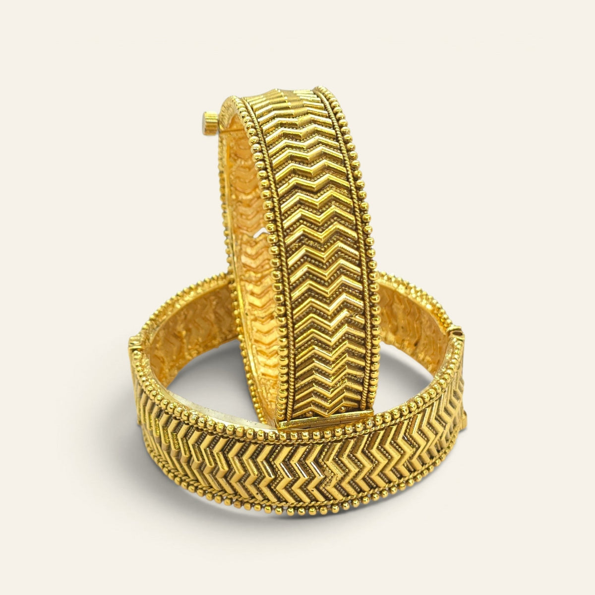 Close-up of chevron zigzag pattern on antique gold plated bangle