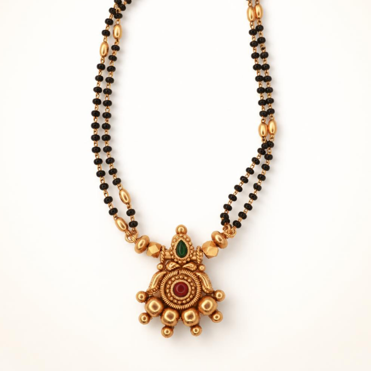 Double strand black bead gold mangalsutra with large star-shaped pendant featuring ruby and emerald stone accents