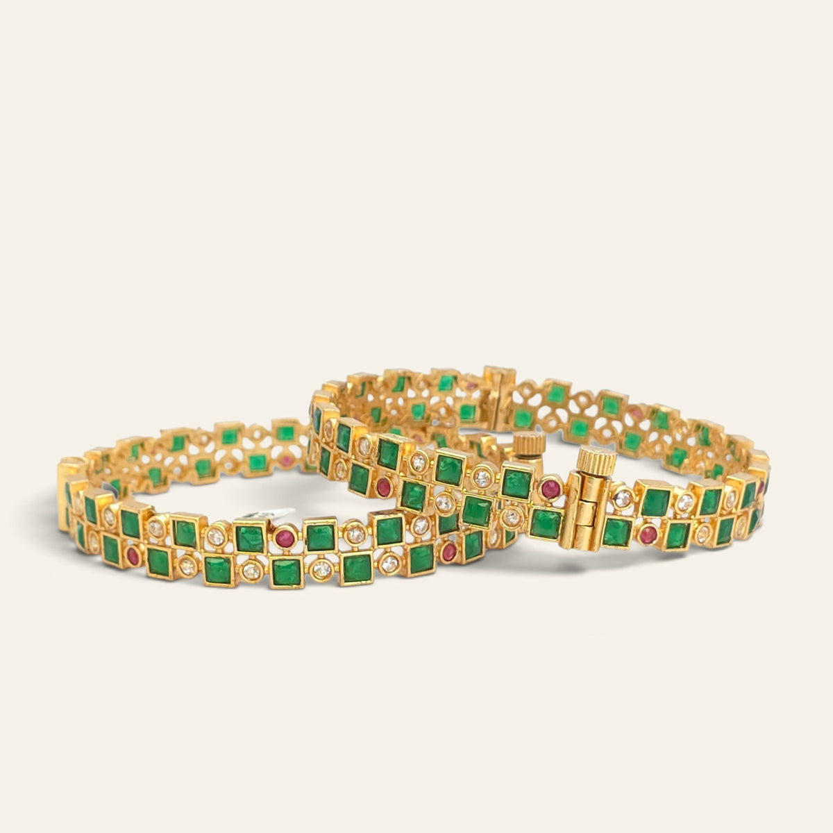 Pair of emerald green checkerboard bangles standing upright showing screw fitting closure