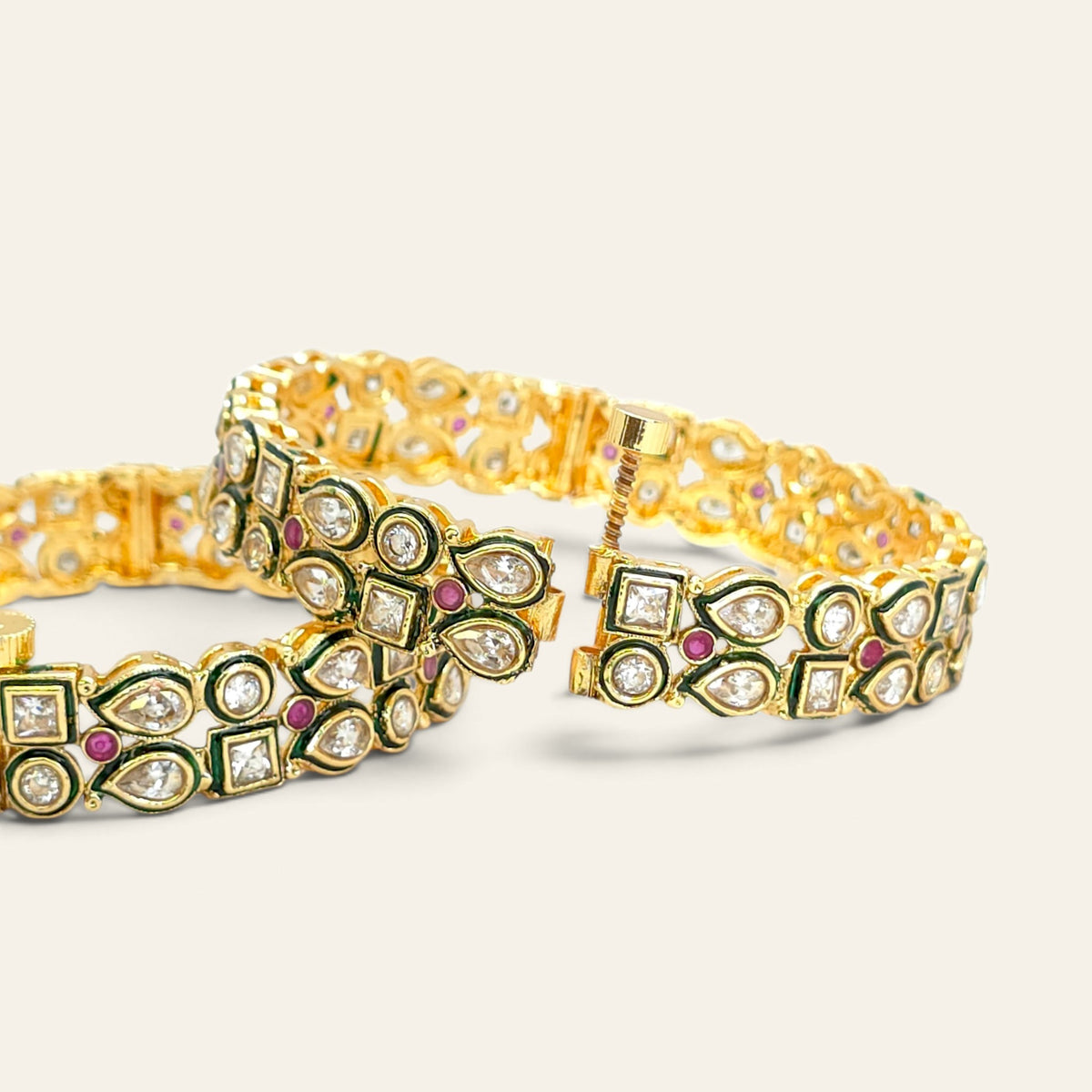 Kundan gold plated bangles with ruby accents and green meenakari work, pair view