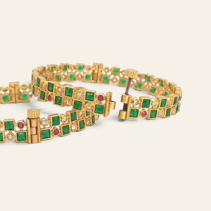Emerald green gold plated bangles with ruby accents, checkerboard pattern, pair lying flat