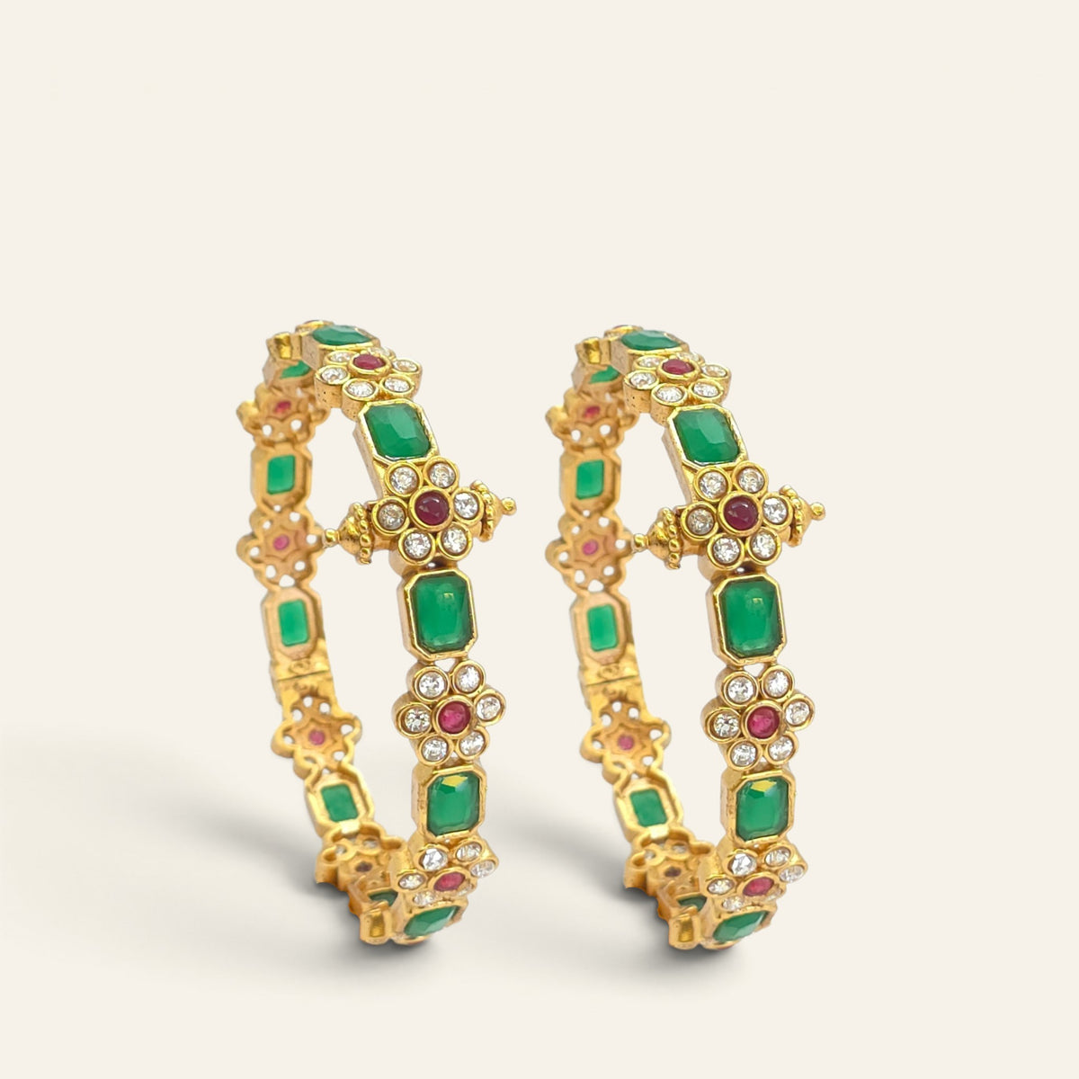 Emerald green floral ruby gold plated bangles, pair standing upright side view