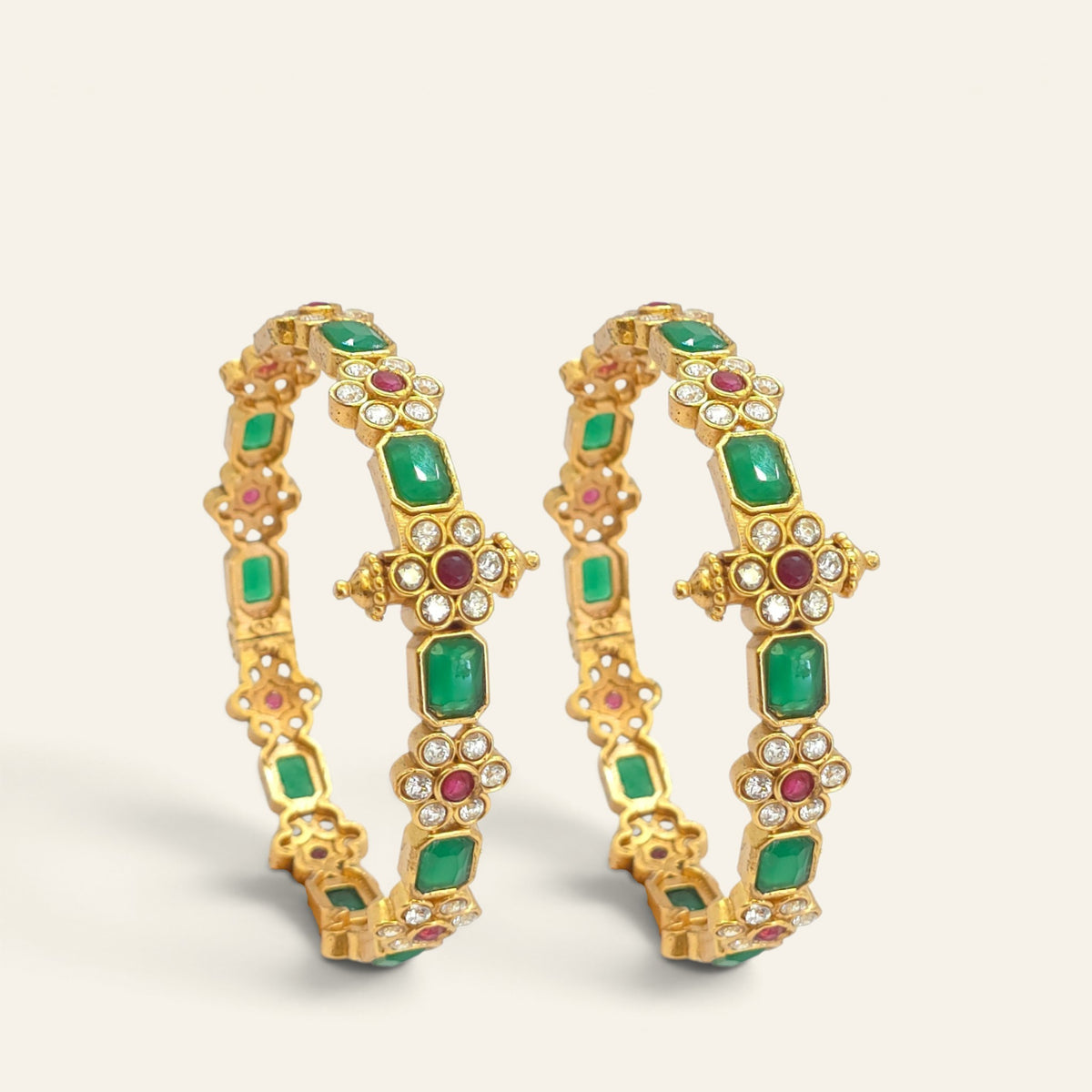 Close-up of emerald green floral ruby gold plated bangle showing cross medallion detailing