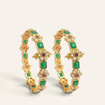 Close-up of emerald green floral ruby gold plated bangle showing cross medallion detailing