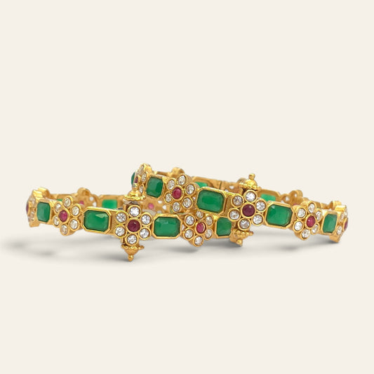 Emerald green floral ruby gold plated bangles, pair lying flat overlapping