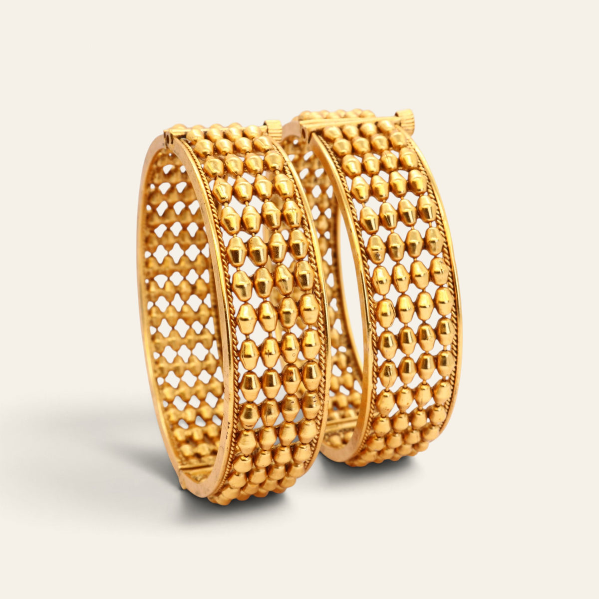 Pair of wide gold-tone openwork bangles with bead-like rows