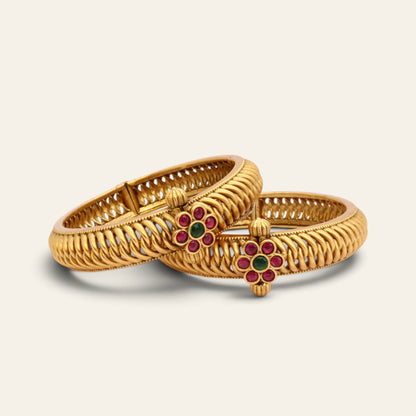 Red and green floral kundan gold-plated kada bangles with twisted openwork, pair