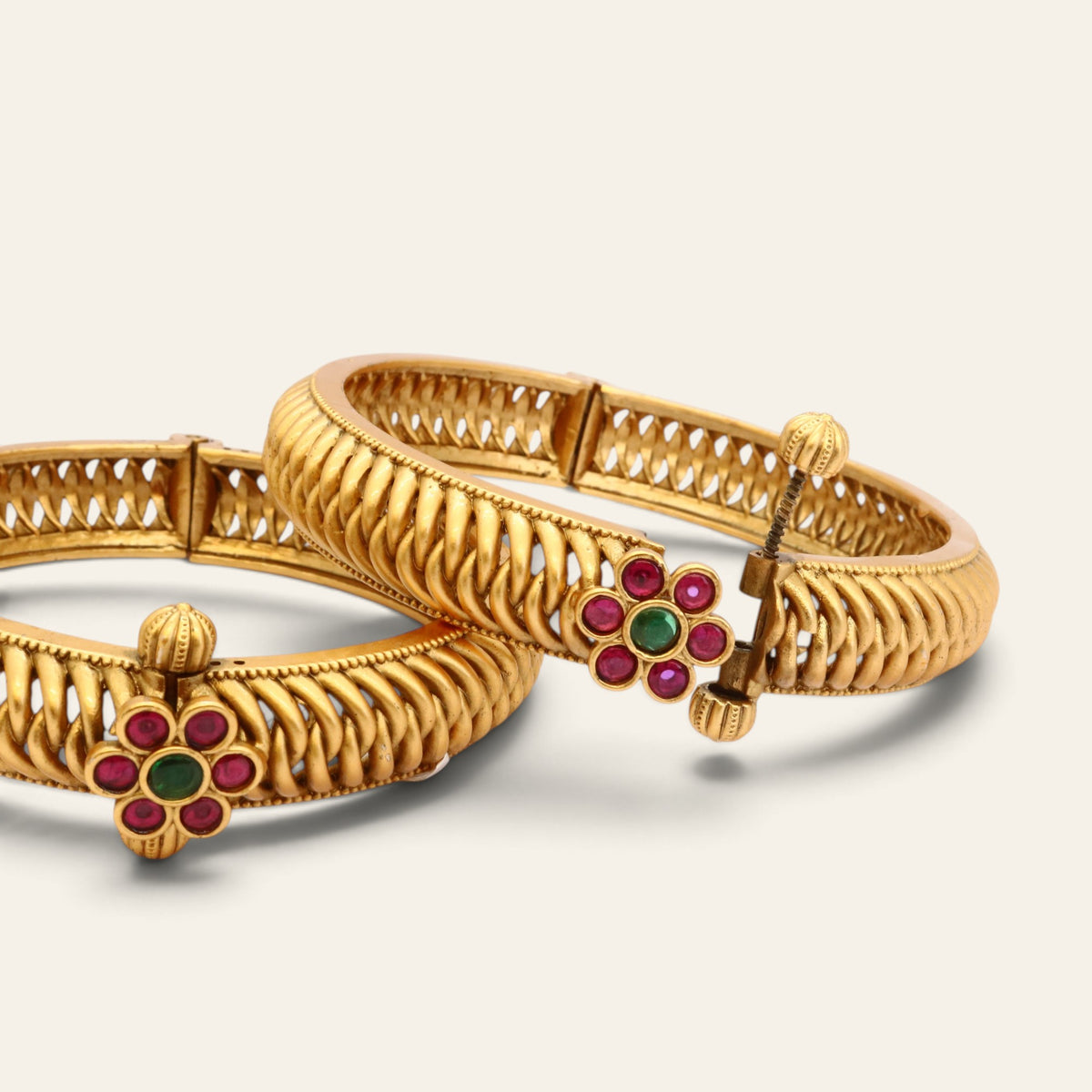 Pair of gold-plated kada bangles with red and green kundan glass stone accents