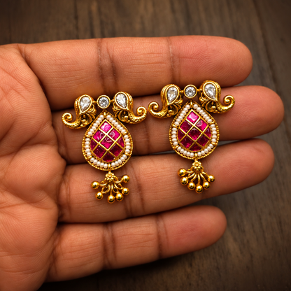 Matching ruby Meenakari gold plated statement earrings close-up