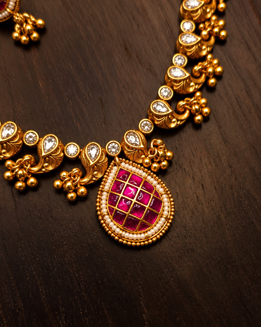 Close-up of Meenakari pendant with moissanite stones and pearl-look border