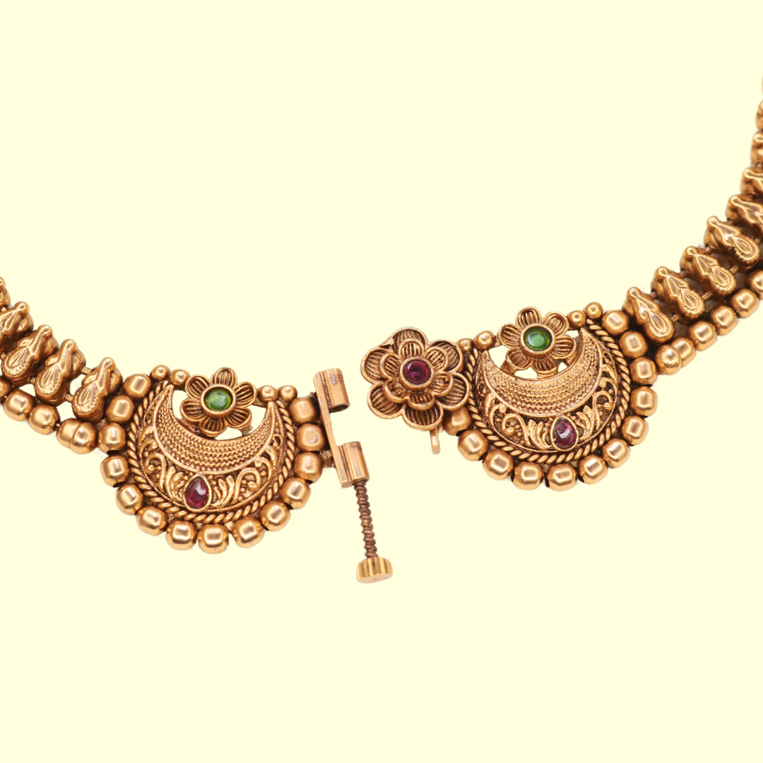 Front clasp detail of Chandbali choker necklace showing screw-pin mechanism with floral ruby centre