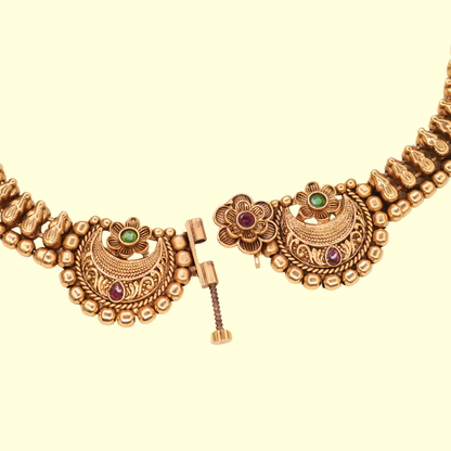 Front clasp detail of Chandbali choker necklace showing screw-pin mechanism with floral ruby centre