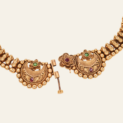 Front clasp detail of Chandbali choker necklace showing screw-pin mechanism with floral ruby centre