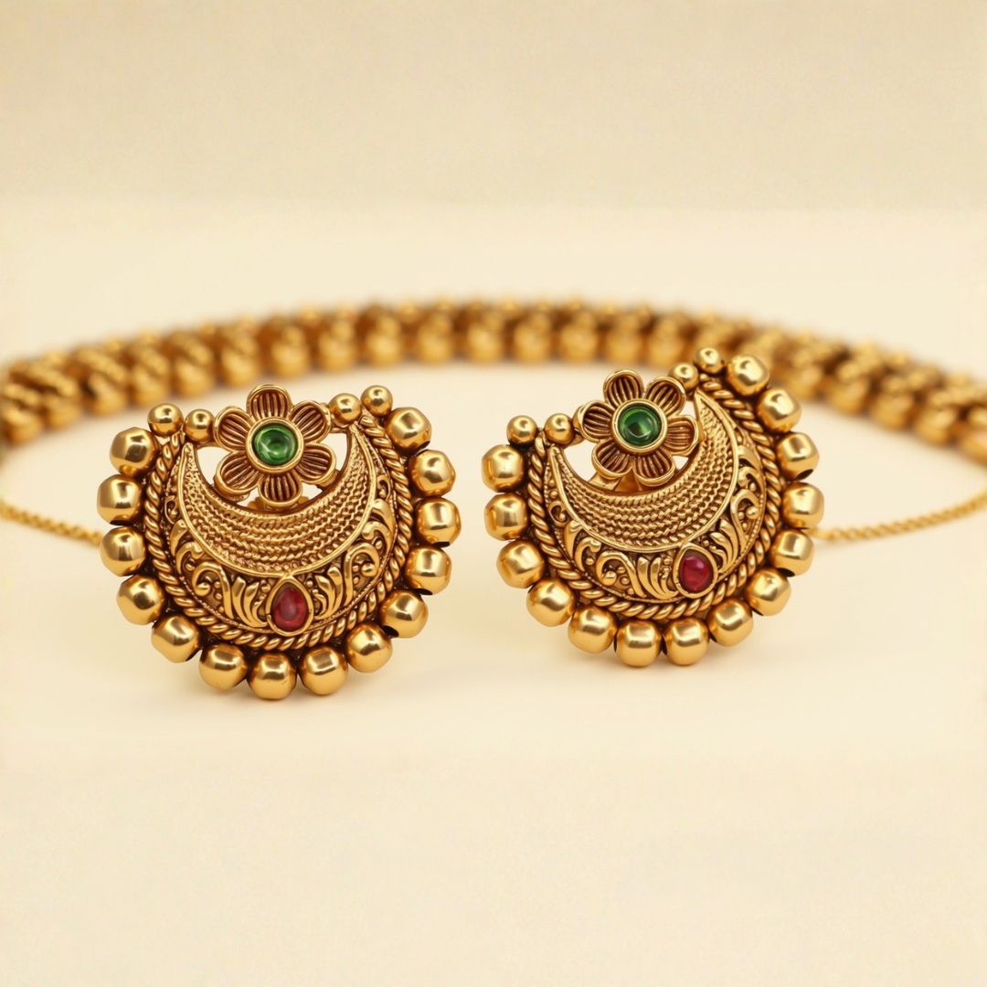 Chandbali stud earrings antique gold with emerald top and ruby base and gold bead petal border - close-up