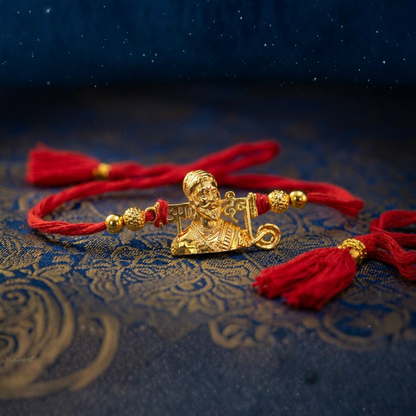 Close-up of Shivaji Maharaj gold-plated pendant rakhi showing detailed portrait engraving – Jija Jewellery
