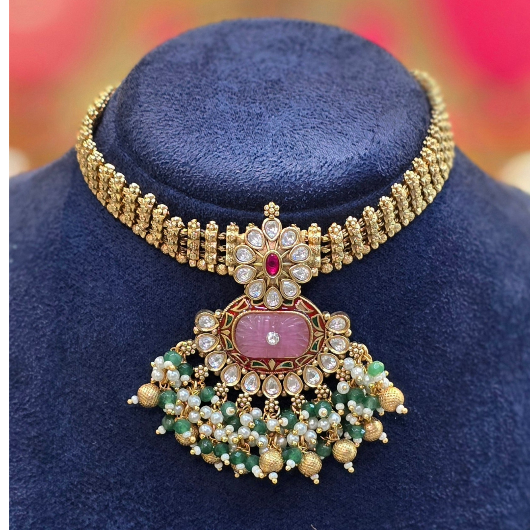 Close-up of PadmaRatna pink Kundan stone choker showing intricate gold-plated detailing and pearl accents