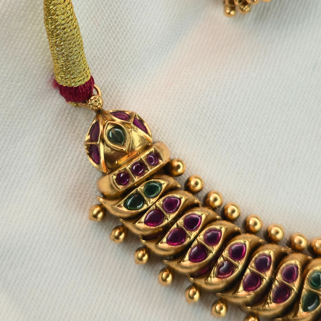 Shinde Shahi Kemp Choker necklace detail on white fabric — antique gold finish