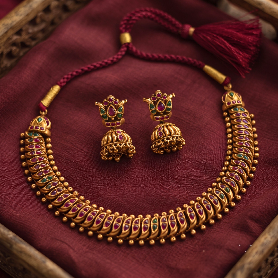 Lotus Jhumka Earrings with ruby and emerald kemp stones close-up