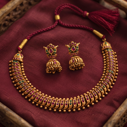 Lotus Jhumka Earrings with ruby and emerald kemp stones close-up
