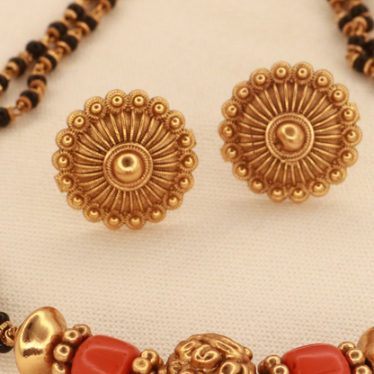 Antique gold sunflower disc stud earrings with radiating ridged petals, matching the coral gold mangalsutra set by Jija Jewellery