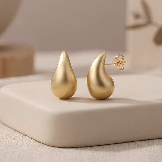 Matte gold teardrop stud earrings in viral waterdrop shape, anti-tarnish drop studs by Jija Jewellery