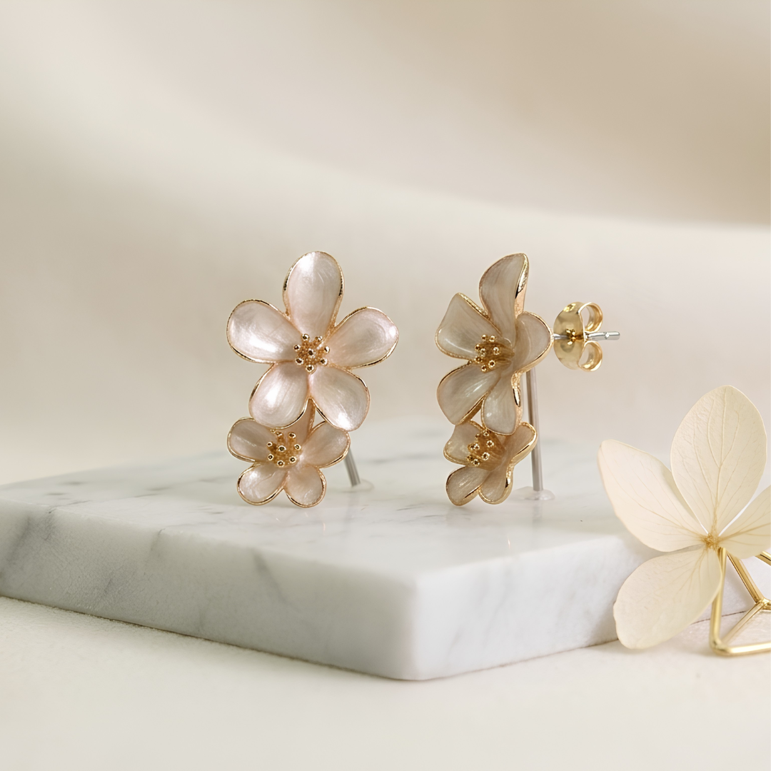 Floral gold-tone push-back stud earrings, cream ivory enamel petals close-up