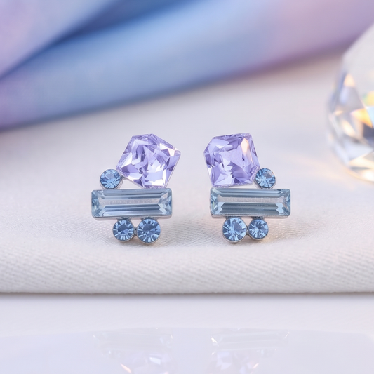 Geometric crystal studs with faceted lavender cube and blue baguette, silver-tone setting