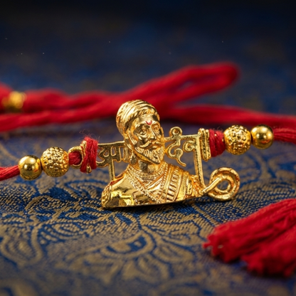 Gold-Plated Shivaji Maharaj Rakhi with red mauli thread on golden fabric – Jija Jewellery Satara
