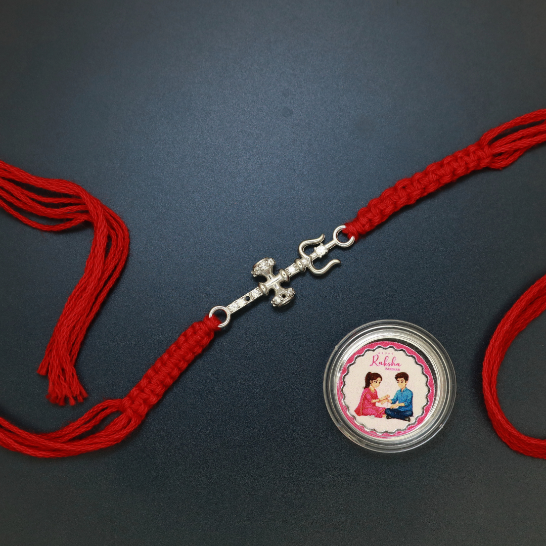 Sterling silver Trishul and Damru rakhi of Lord Shiva with zircon studding on red thread