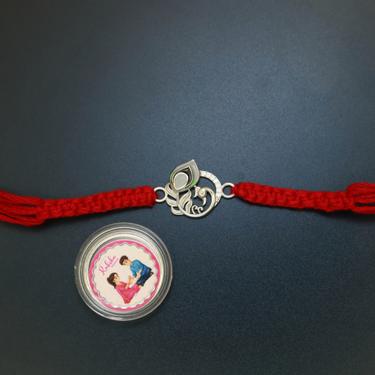 92.5 sterling silver peacock rakhi with green meenakari enamel, zircon and mother-of-pearl centre stone on red thread