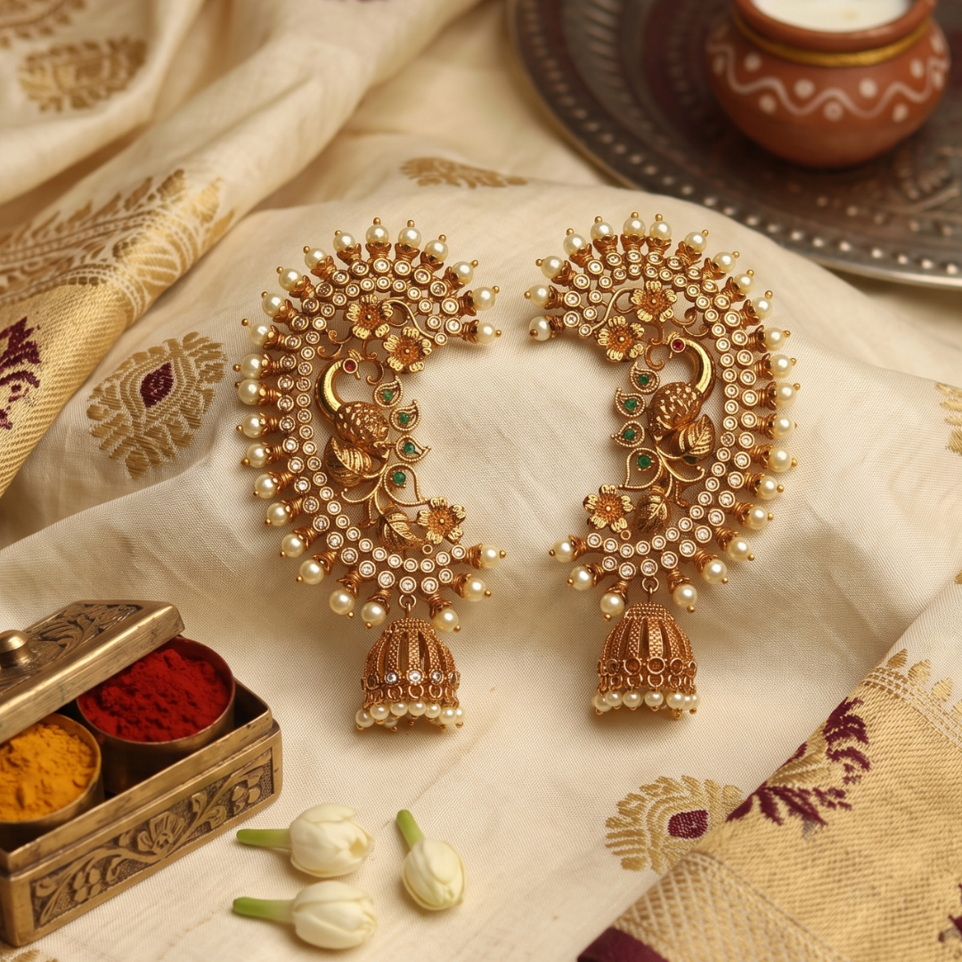 Antique gold-plated peacock ear cuffs with CZ florets, green and ruby accents, pearl fringe and jhumka drops, handcrafted Maharashtrian bridal temple jewellery by Jija Jewellery Satara