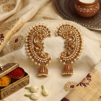 Antique gold-plated peacock ear cuffs with CZ florets, green and ruby accents, pearl fringe and jhumka drops, handcrafted Maharashtrian bridal temple jewellery by Jija Jewellery Satara