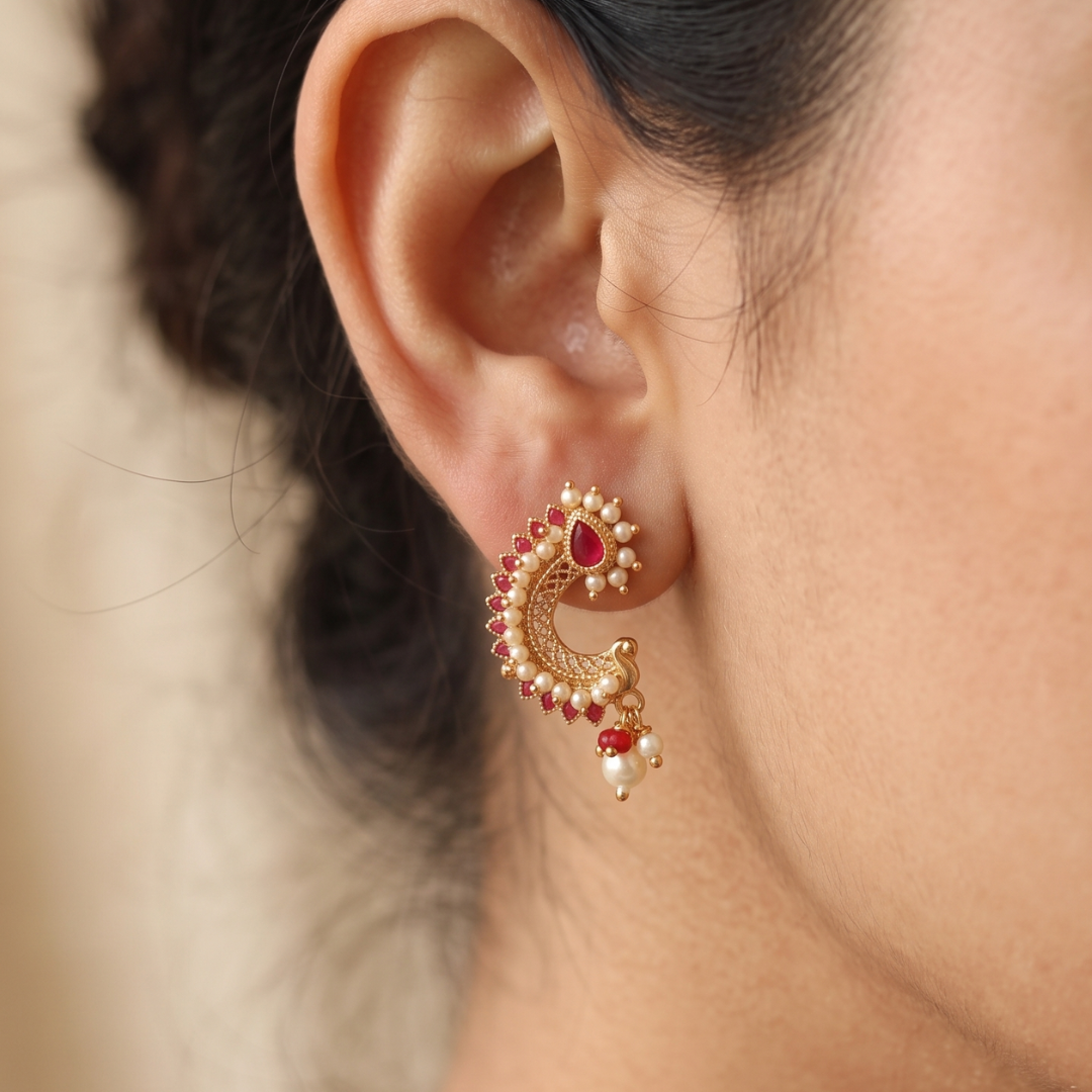 Antique gold-plated peacock stud earrings with ruby-red stones and white pearls, handcrafted temple jewellery by Jija Jewellery Satara