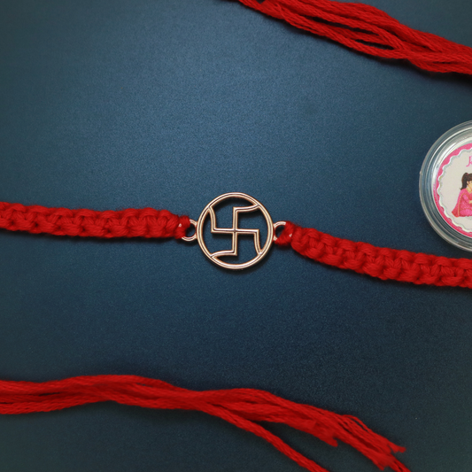 Rose gold plated sterling silver Swastik rakhi with open-work Shubh motif on braided red thread