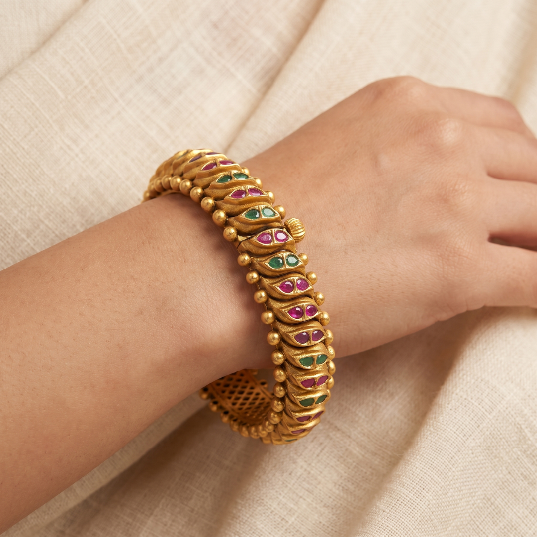 Antique gold kada bangles with red and green semi-precious stones