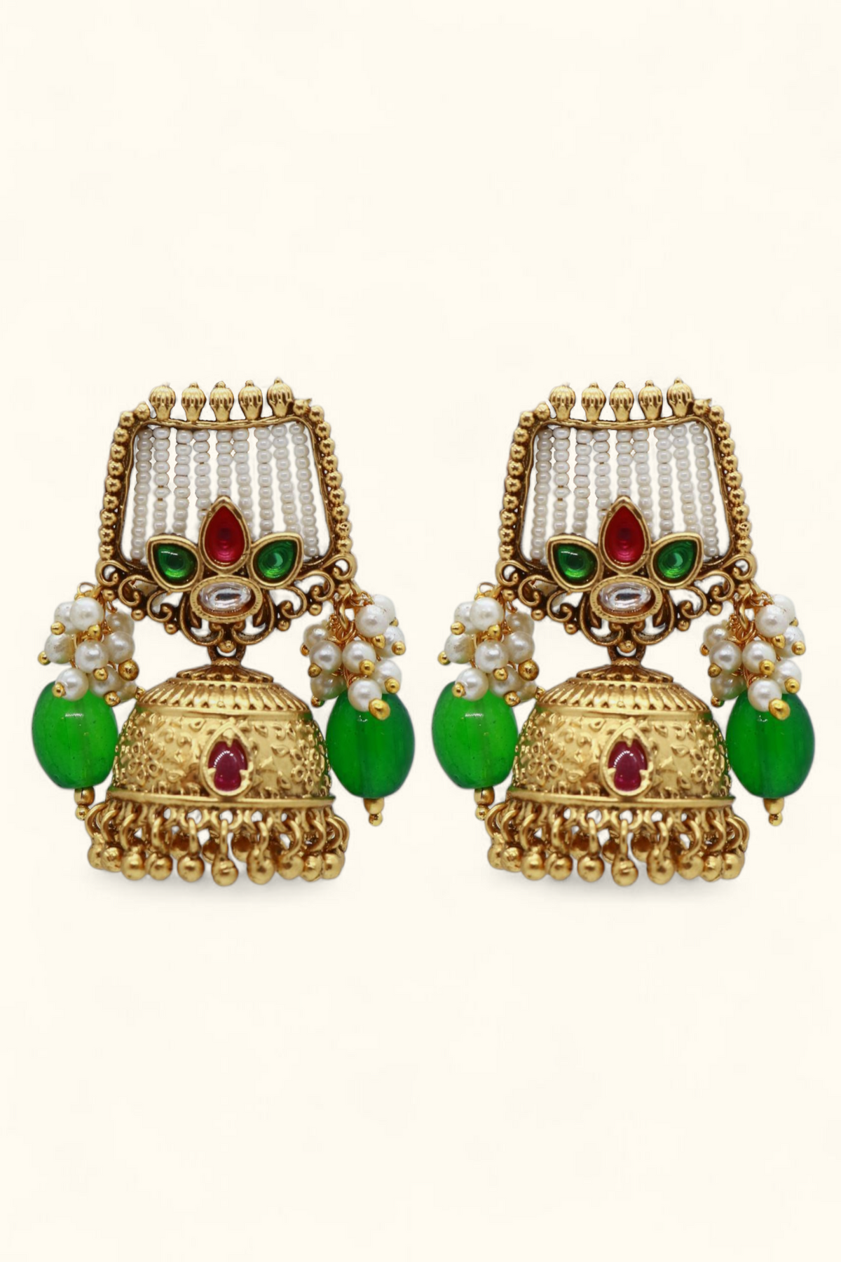 Antique pearl jhumka earrings with green drops and ruby stones on white background