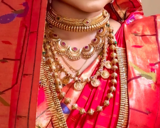 Chandrakor crescent choker layered with traditional Maharashtrian bridal necklaces over a red Paithani saree