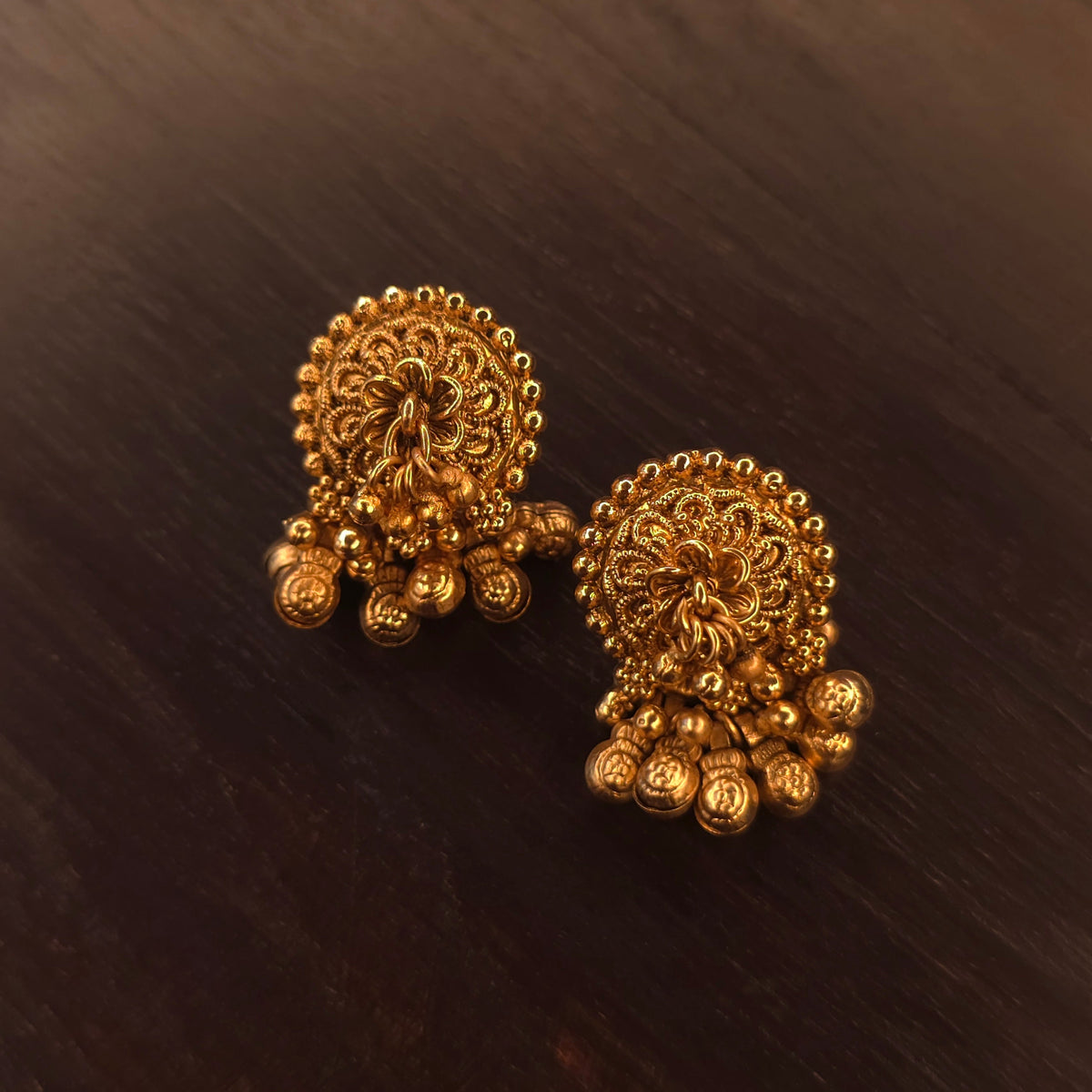 Close view of gold plated floral filigree stud earrings with ghungru bead drops from the Ghungru Necklace Set – Jija Jewellery