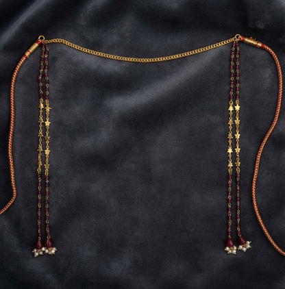 Gold plated crystal stone Mundavalya with red drops and pearl clusters on dark velvet, traditional Maharashtrian bridal jewellery