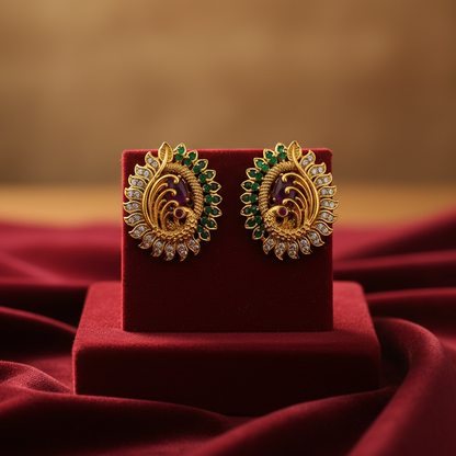 Gold plated peacock earrings with green and pink stones on velvet stand – Jija Jewellery