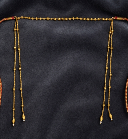 Gold plated bead chain mundavalya on dark velvet, traditional Maharashtrian bridal forehead jewellery