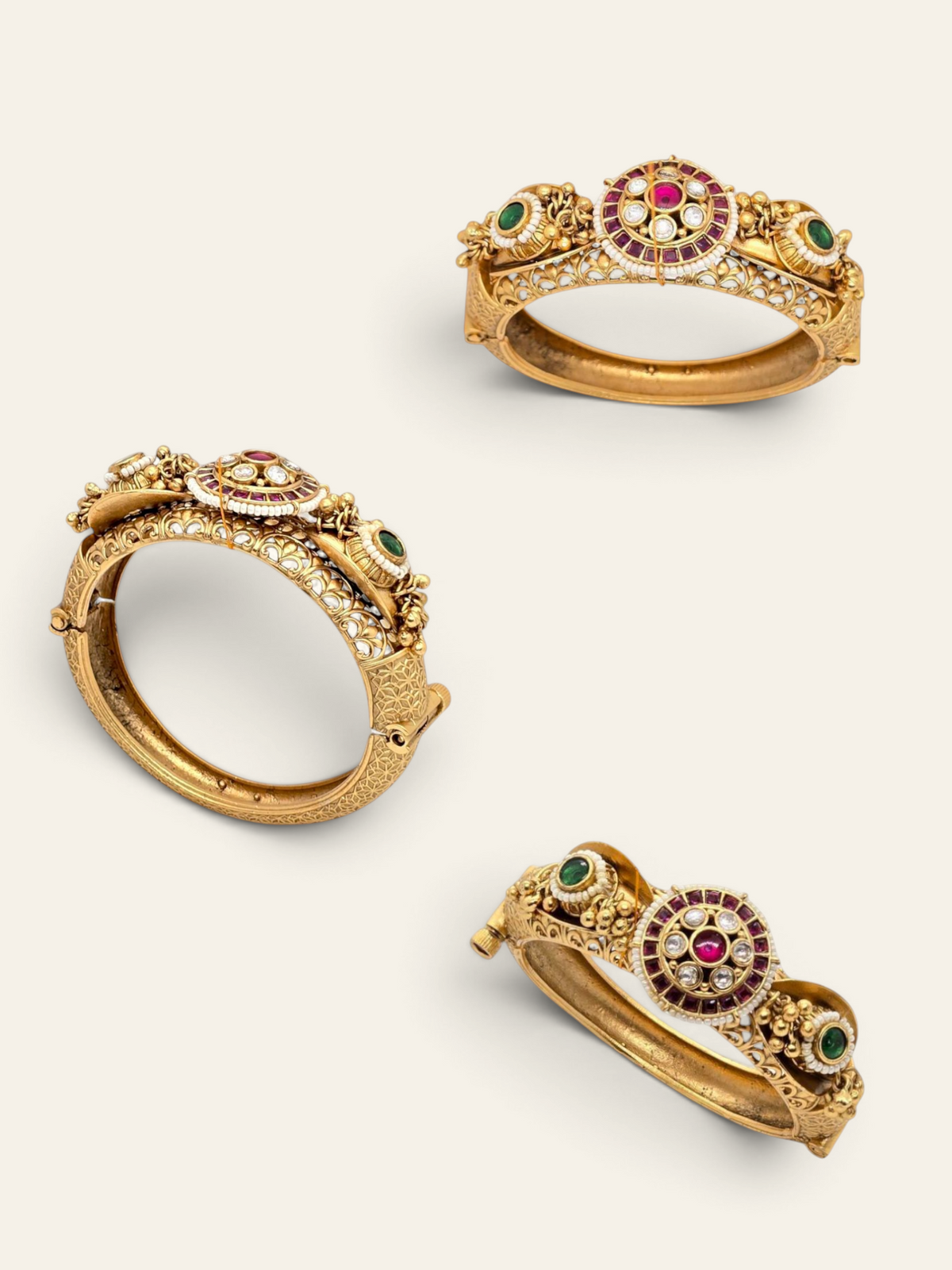 Jija Jewellery Heritage Glow Kundan Kada featuring gold-plated metal, ruby and emerald stones, and intricate detailing.