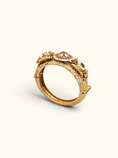 Jija Jewellery gold plated Rajwada Kundan Kada bangle with intricate engravings and multi-colored stone accents.